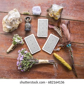 Dry flowers, a thistle, a staff of feathers, a crystal of quartzite and candles made from natural wax, witchcraft, spells, magic, wicca, goddess, tarot cards