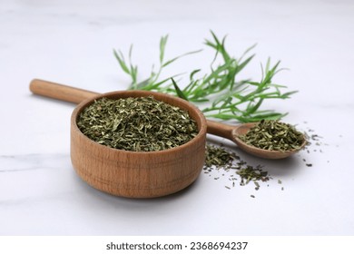Dry and fresh tarragon on white table - Shutterstock ID 2368694237
