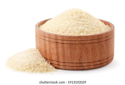 Dry gelatin granules in a wooden bowl close-up on a white background. Isolated