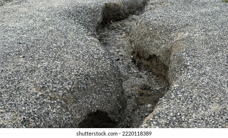 Dry ground covered with rubble. A dried-up riverbed. Background picture.