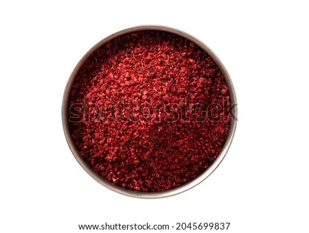 Dry ground sumac in a bowl isolated on a white background. Sumac isolated top view.