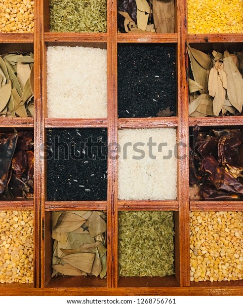 Dry herbs\
medicine and grains in divide wooden\
box.