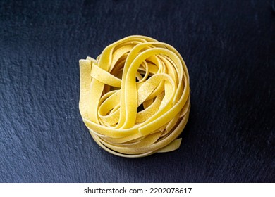 Dry Italian tagliatelle pasta background healthy food photo Top view Close-up - Powered by Shutterstock