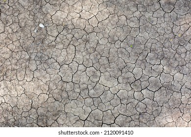 Dry Land Because It Doesn't Rain. Drought Creates An Unhealthy Life. High Resolution Photo Source. The Ground, The Soil, The Mud, And The Ground Are Split.