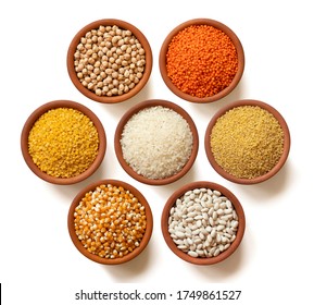 Dry legumes in arranged ceramic bowls Yellow lentils, dry chickpeas, Red lentils, white rice, dry beans, corn seeds, bulgur wheat. Isolated top view. - Powered by Shutterstock