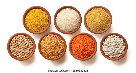 Dry legumes in arranged ceramic bowls Yellow lentils, dry chickpeas, Red lentils, white rice, dry beans, corn seeds, bulgur wheat. Isolated top view. - Powered by Shutterstock
