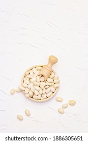 Dry Lima Bean Or Kidney Bean In Glass Jar. A Valuable Source Of Protein For A Healthy Vegan Diet. White Putty Background, Top View