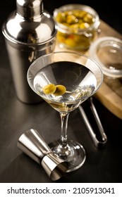 Dry martini drink with green olives.