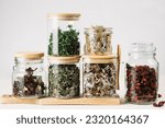 Dry medicinal herbal tea, various ingredients in jars. Alternative medicine.