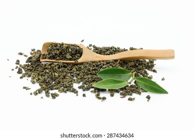 Dry Oolong Tea Leaf From China With Bamboo Scoop On White Background.