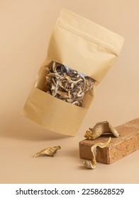 Dry oyster mushrooms in eco bag package on the beige background - Shutterstock ID 2258628529