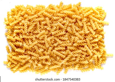 Dry pasta fusilli. Fusilli have spiral shape and yellow color. Pasta is delicious Italian traditional food made from wheat flour like noodles.Pasta background.Top view - Powered by Shutterstock