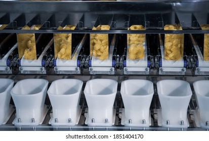 Dry Pasta On Automatic Combination Weighers. Multihead Weighers Machine In Food Industry.