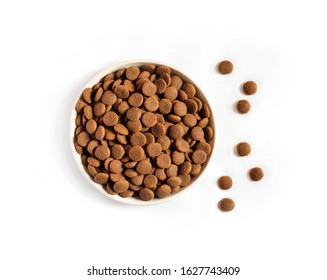 Dry Pet Food In A White Ceramic Bowl Isolated On White Background. Flat Lay, Top View. Copy Space