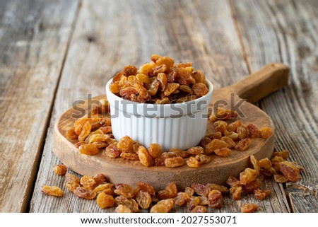 Dry raisins. Dry raisins nuts on wood floor. Bulk raisins grains. Raisins on a ceramic plate