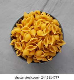 Dry Raw Conchiglie Pasta in a Bowl, top view. Flat lay, overhead, from above.  - Powered by Shutterstock