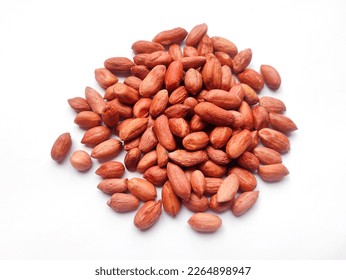 Dry raw peanuts without shell isolated on white background. Peanuts are also known as groundnut, earthnut, goober or monkey nut.Heap of peanuts.Close up view of peanut, groundnut.Unpeeled red peanuts.