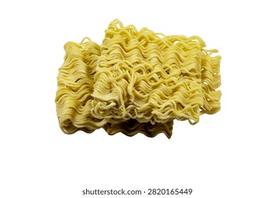 A dry, rectangular block of uncooked instant ramen noodles featuring a wavy, layered texture. The pale yellow wheat strands are tightly packed,...