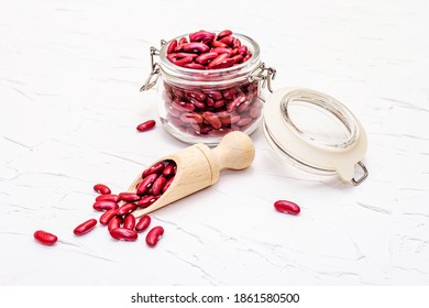 Dry Red Bean Or Kidney Bean In Glass Jar. A Valuable Source Of Protein For A Healthy Vegan Diet. White Putty Background, Close Up