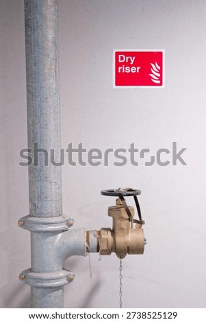 Dry riser landing valve within office building