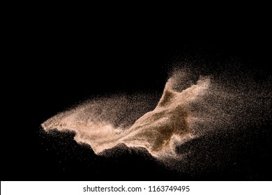 Dry River Sand Explosion. Golden Colored Sand Splash Agianst Dark Background.