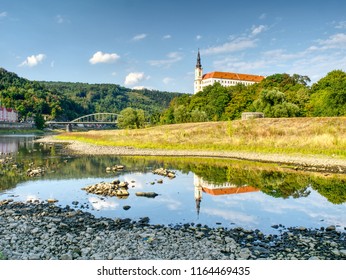 Dry Riverbed Of River Elbe In Decin, Czech Republic, Summer 2018. Empty River Bed With Poisoned Muddy Water. Decin Castle Above Old Railway Bridge.