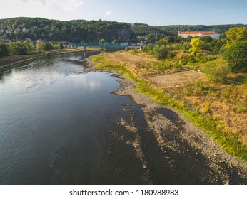 Dry Riverbed Of River Elbe In Decin, Czech Republic, Summer 2018. Empty River Bed With Poisoned Muddy Water. Decin Castle Above Old Railway Bridge.