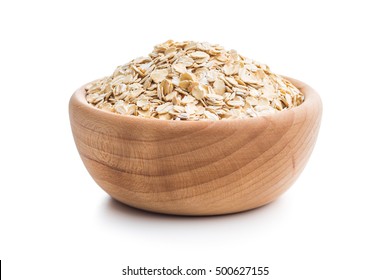 Dry rolled oatmeal in wooden bowl isolated on white background. - Powered by Shutterstock