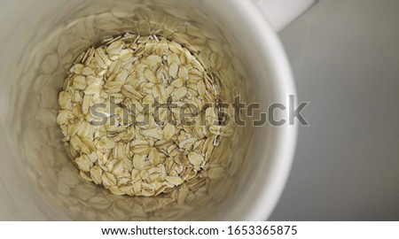 Dry rolled oats in a cup