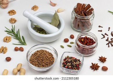 Dry Spices In Glass Jars. Cardamom In Mortar And Pestle. White Background. Top View