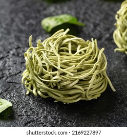 Dry Spinach Noodles On Rustic Dark Background