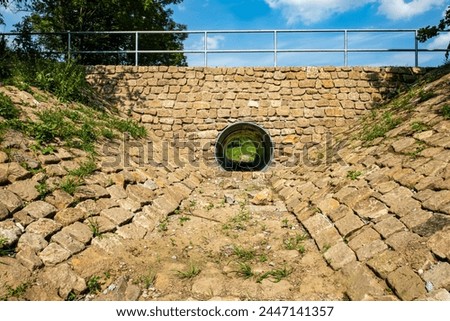 Similar – Image, Stock Photo Look through stone pipes with resistant glaze placed on the ground in front construction site