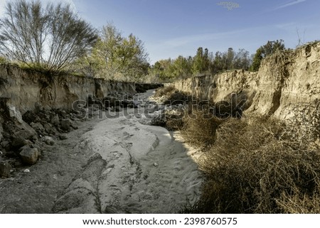 dry stream basin with sand in the bed