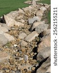 Dry streambed creek bed lined with large rocks