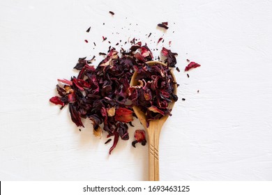 Dry Tea Leaves Of Red Hibiscus In A Wooden Spoon. Detox Drink. 