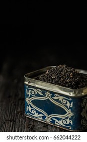 Dry Tea In An Old Tin Box On A Dark Wooden Table. Dark Photo. Space For Your Text. Rustic