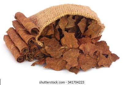 Dry tobacco leaves in sack over white background