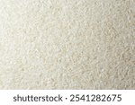 Dry Uncooked White Rice Background - Top View, Flat Lay. Scattered Raw Long Grain Rice. Asian Cuisine and Culture. Healthy Eating Ingredients. Diet Food