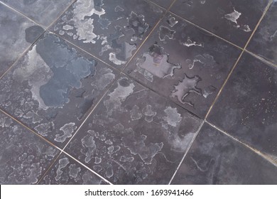 Dry water stains on the tile floor in the bathroom