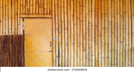 Dry weave door with bamboo wall and copy space on right. Part of home or house built by natural material. Wooden pattern wallpaper. Vintage structure and Exterior or Interior design concept 