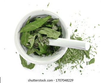 Dry wild garlic spice (Allium ursinum) in a mortar and pestle isolated on white background- bear leek. Spice preparation.