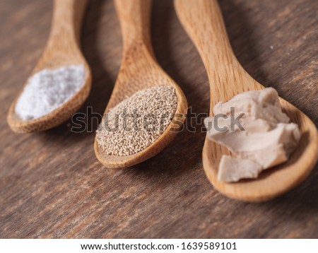 dry yeast, fresh yeast and instant yeast on top view wood table composition