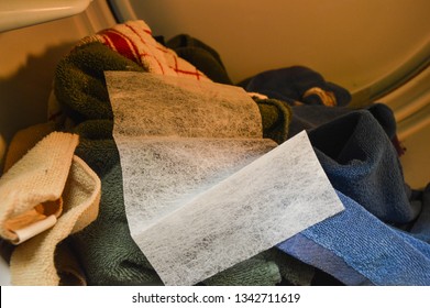 Dryer Sheet In Dryer Used As A Fabric Softener, Dryer Sheet In Dryer On Towels And Clothing, White Dryersheet