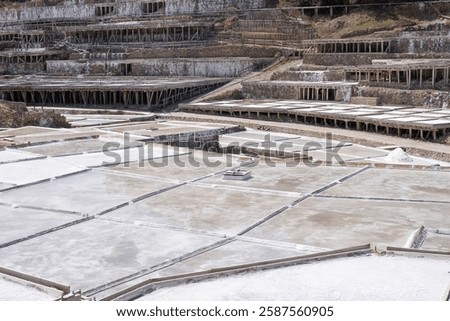 drying beds or crystallizing ponds in a salt plant with some terraces at the background, salt production by evaporation of salt water in sal pans, Añana salines, Alava, Spain