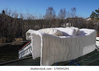 Drying Blanket And Pillows In The Sun 