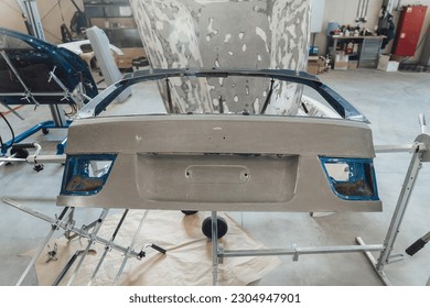 Drying car parts after applying primer. Preparing car body parts for painting - Powered by Shutterstock