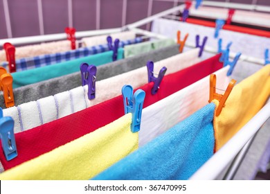 Drying of clothes colored house on a background of the tiles in the laundry room.