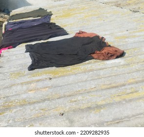 Drying Clothes On The Asbestos House