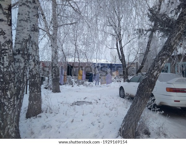 drying clothes in the village of\
Siberia on a rope in winter hanging things on the street\
car