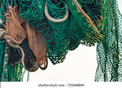 Drying fishing nets on the trawler in city harbor at sunset of the day